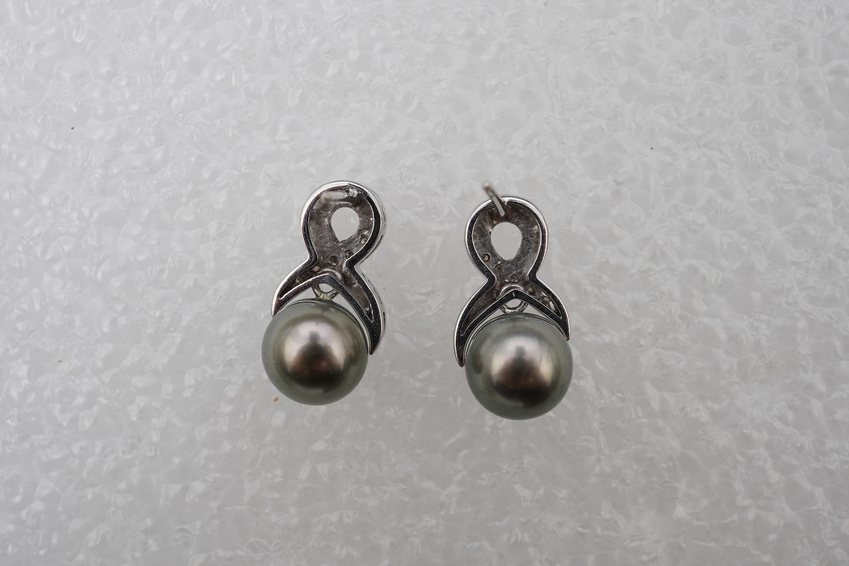 A pair of cultured pearl and diamond earrings